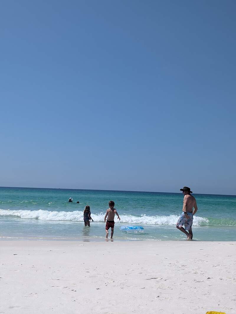 Eve and Noah playing in the waves